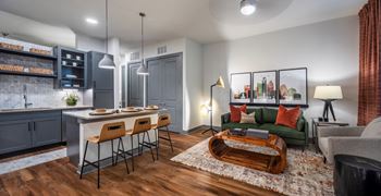 Aura thirty2 new apartments in austin, texas model living room with hardwood flooring